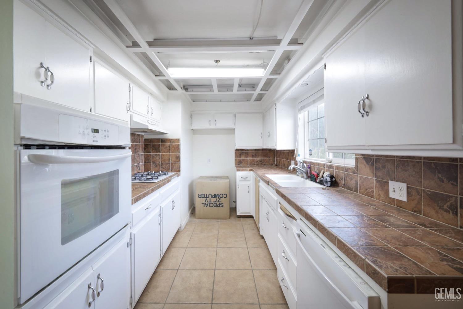 Undisclosed Address Bakersfield, CA 93306 - Photo 12 of 22 a large kitchen with a stove top oven