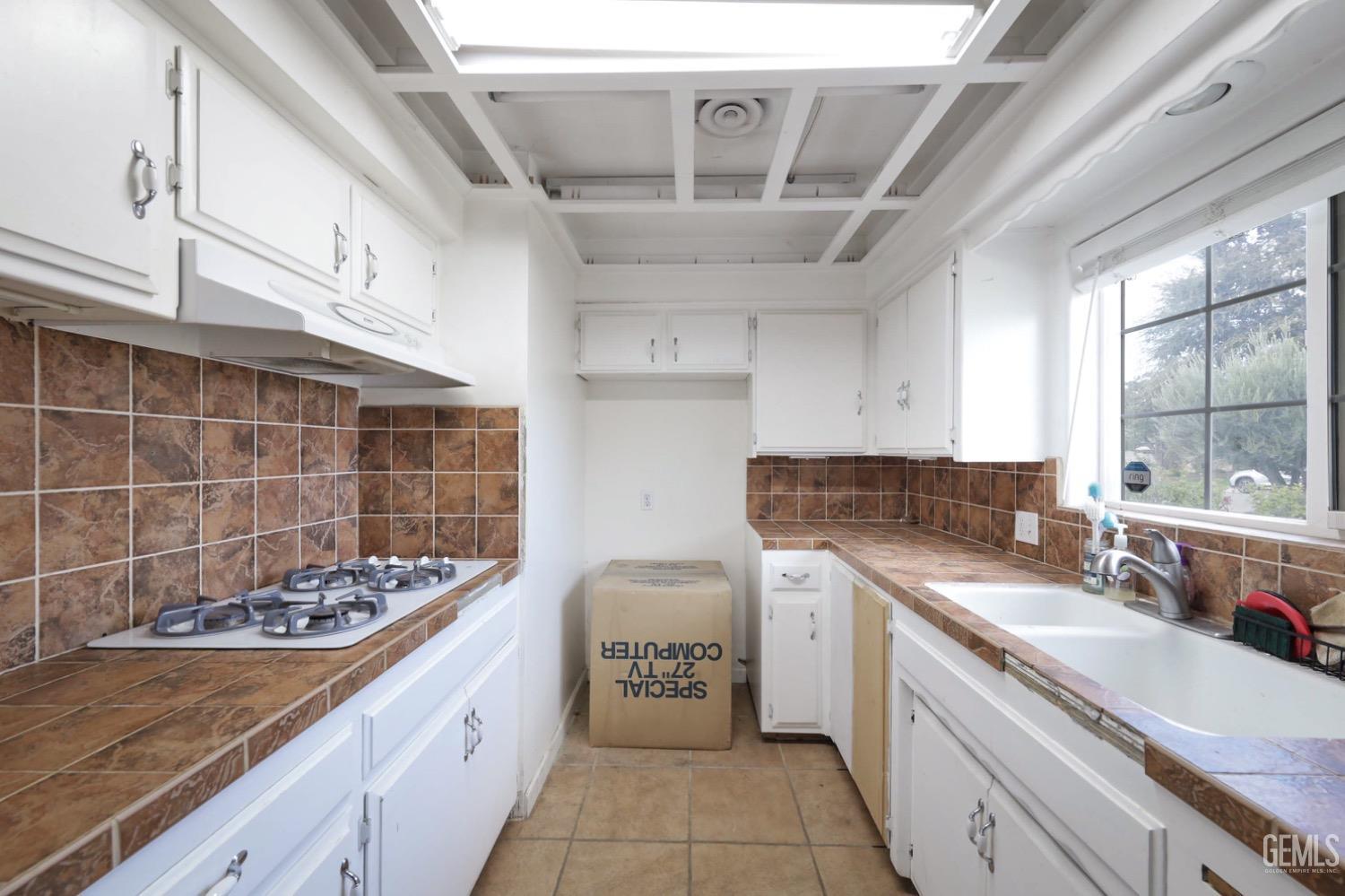 Undisclosed Address Bakersfield, CA 93306 - Photo 13 of 22 a kitchen with a stove a sink a refrigerator and window