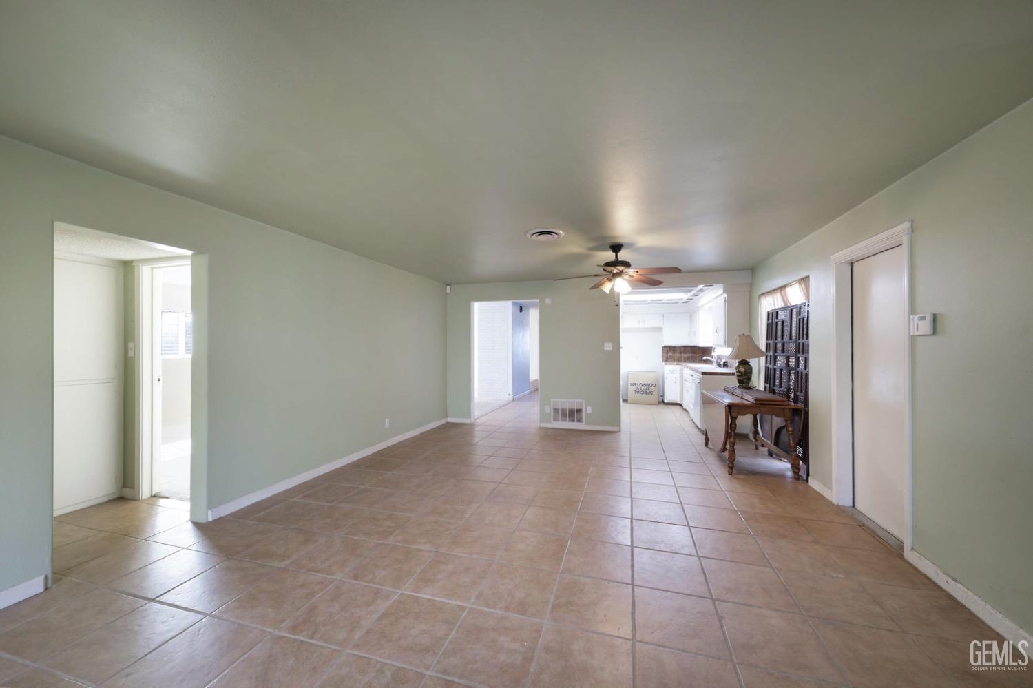 Undisclosed Address Bakersfield, CA 93306 - Photo 19 of 22 a view of a livingroom and a kitchen with furniture and a chandelier fan