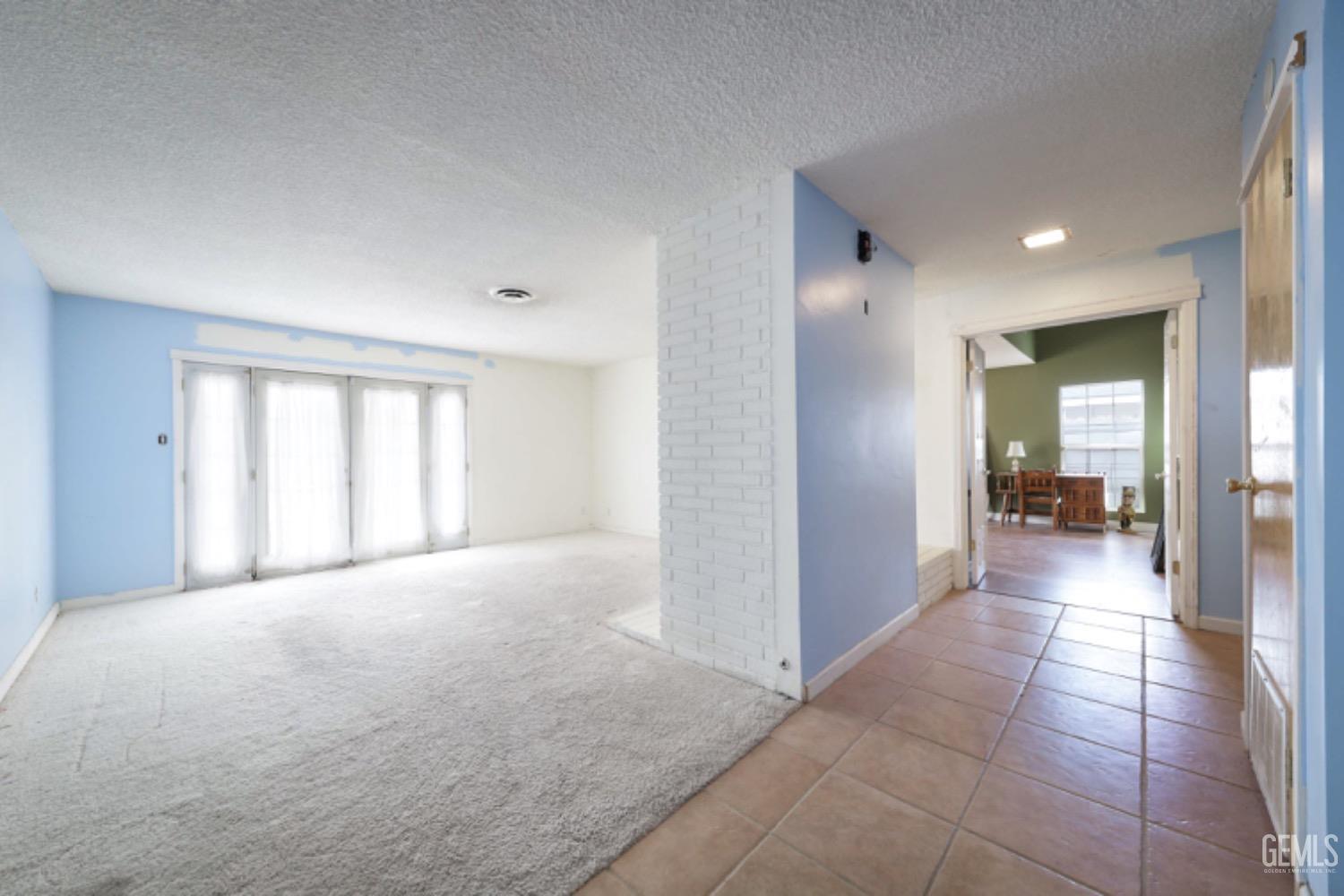 Undisclosed Address Bakersfield, CA 93306 - Photo 9 of 22 a view of a big room with windows and entryway