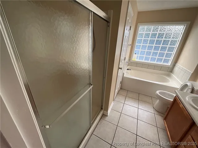 a bathroom with a bathtub and shower