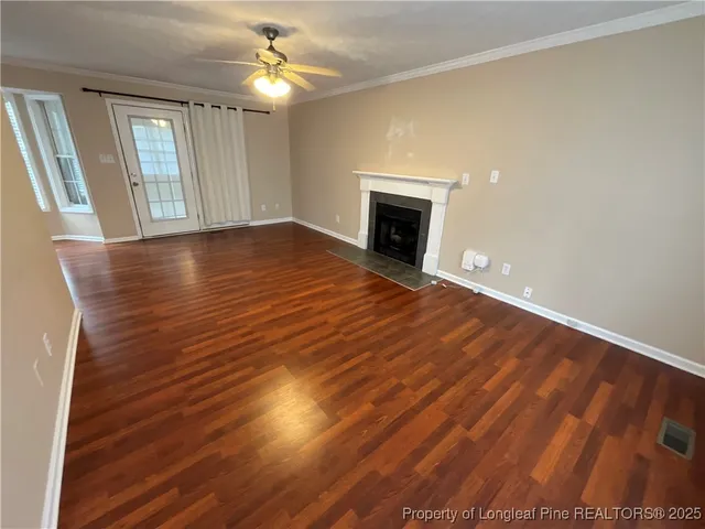 wooden floor in an empty room with a fireplace