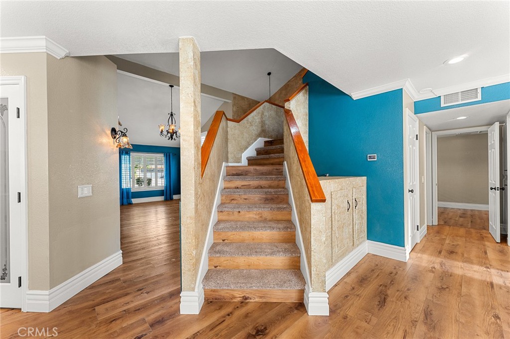 16825 Winterbrook Circle Riverside, CA 92503 - Photo 16 of 42 a view of a hallway with wooden floor and staircase
