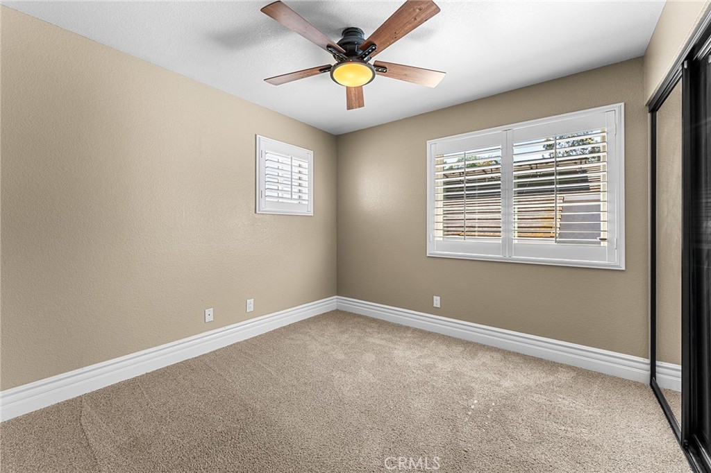 16825 Winterbrook Circle Riverside, CA 92503 - Photo 23 of 42 a view of an empty room with window and a ceiling fan