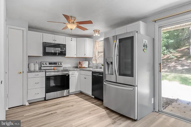 a kitchen with stainless steel appliances a refrigerator stove and sink