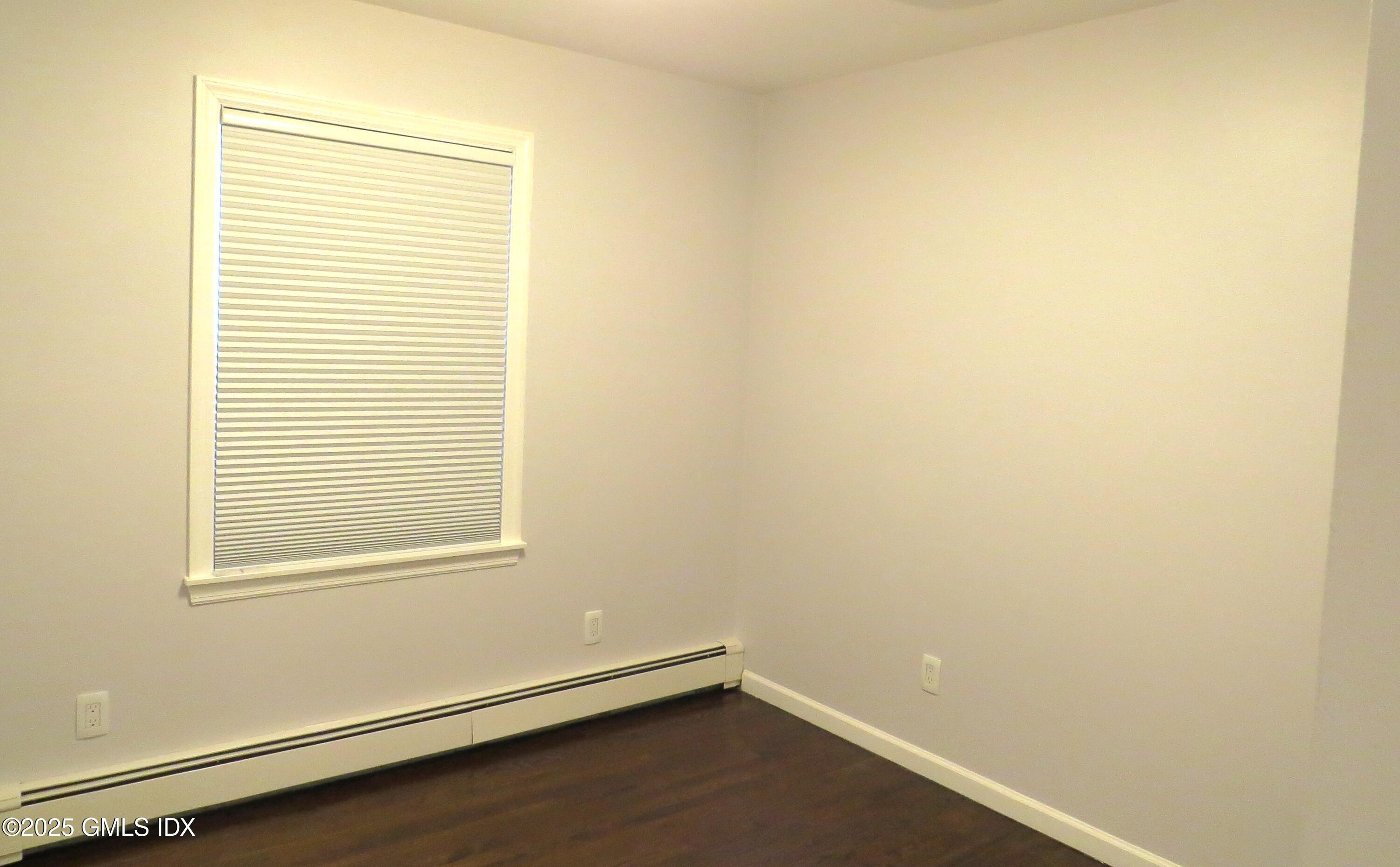68 Pemberwick Road, Unit 1 Greenwich, CT 06831 - Photo 12 of 18 an empty room with a window