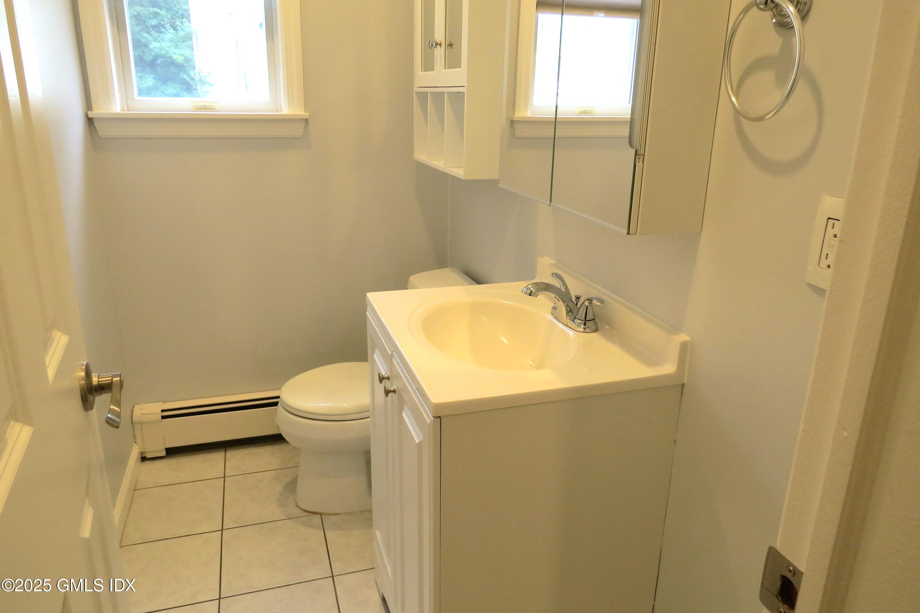 68 Pemberwick Road, Unit 1 Greenwich, CT 06831 - Photo 13 of 18 a bathroom with a sink a toilet and a shower