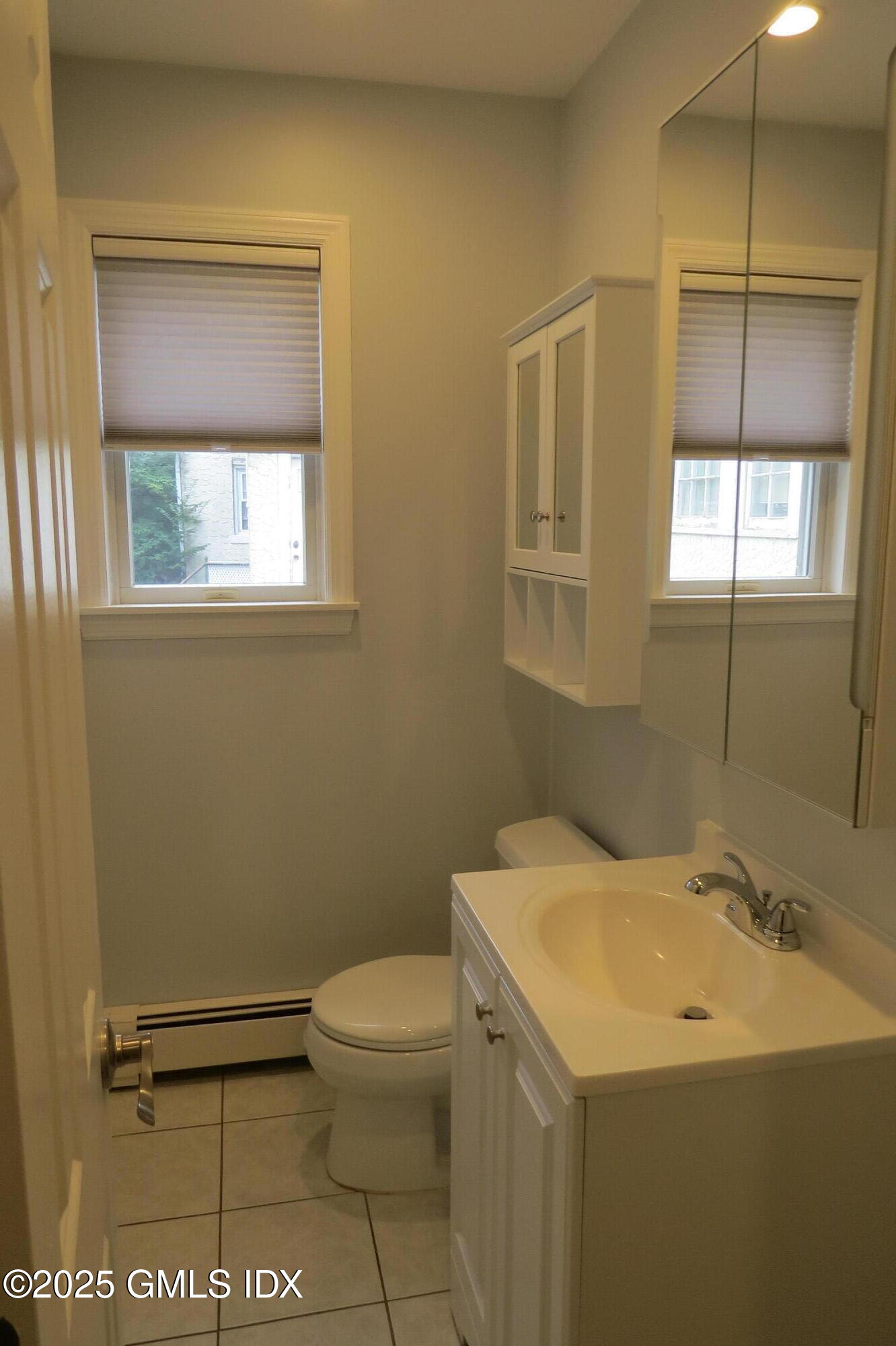 68 Pemberwick Road, Unit 1 Greenwich, CT 06831 - Photo 14 of 18 a bathroom with a sink a toilet and a mirror