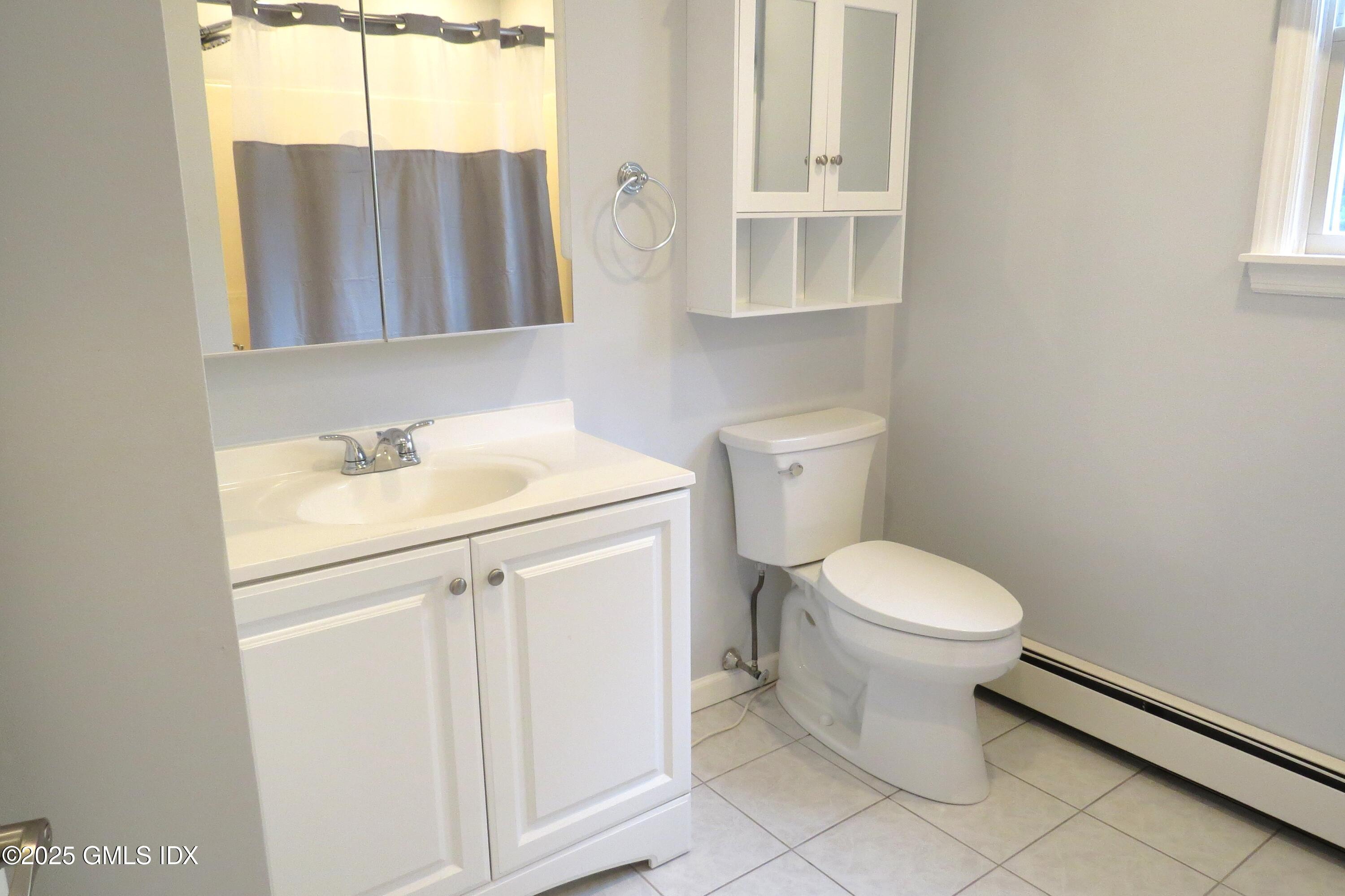 68 Pemberwick Road, Unit 1 Greenwich, CT 06831 - Photo 15 of 18 a bathroom with a sink toilet and mirror