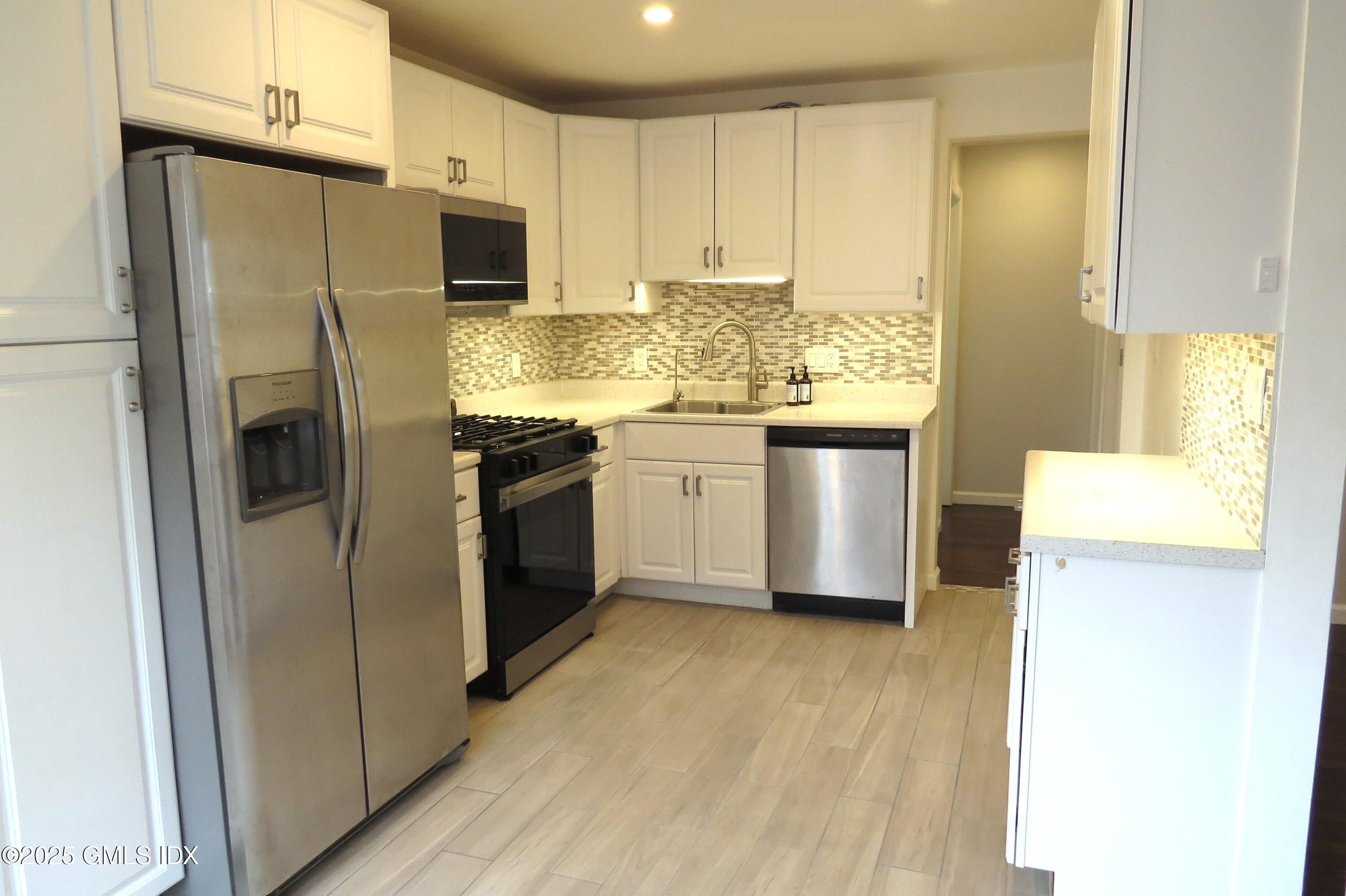 68 Pemberwick Road, Unit 1 Greenwich, CT 06831 - Photo 3 of 18 a kitchen with a refrigerator sink and stove