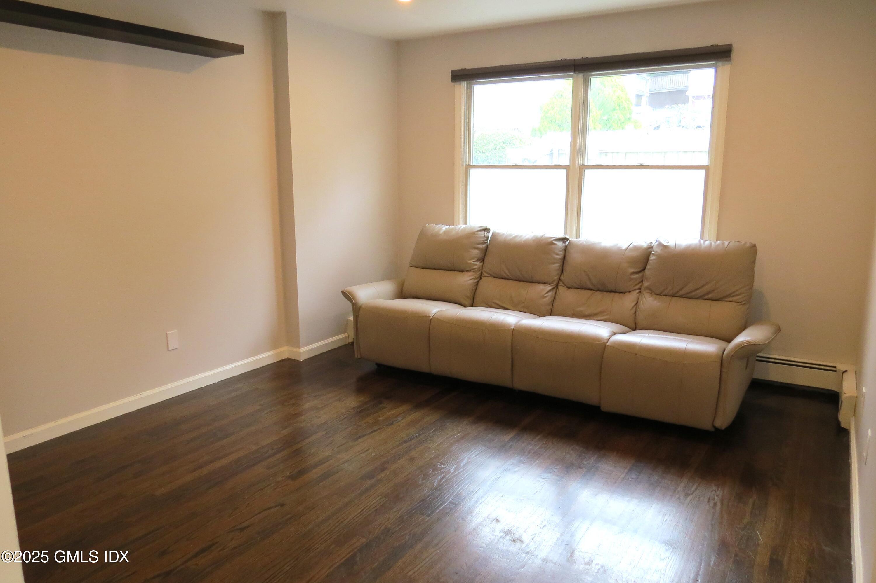 68 Pemberwick Road, Unit 1 Greenwich, CT 06831 - Photo 7 of 18 a living room with furniture and a window