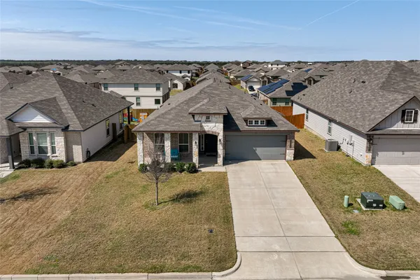 an aerial view of a house with a yard