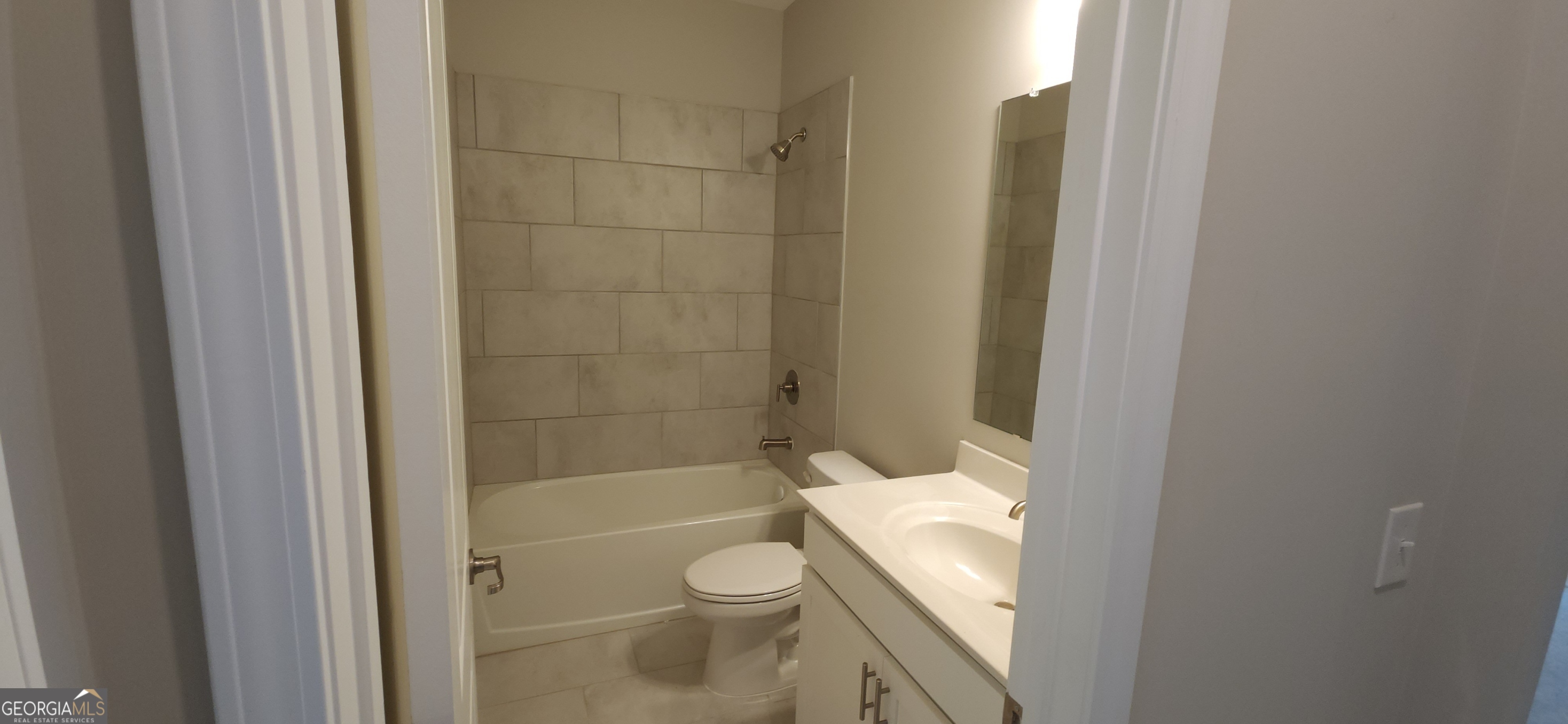 2606 Dorset Lane Grayson, GA 30017 - Photo 11 of 24 a bathroom with a granite countertop bathtub shower and toilet