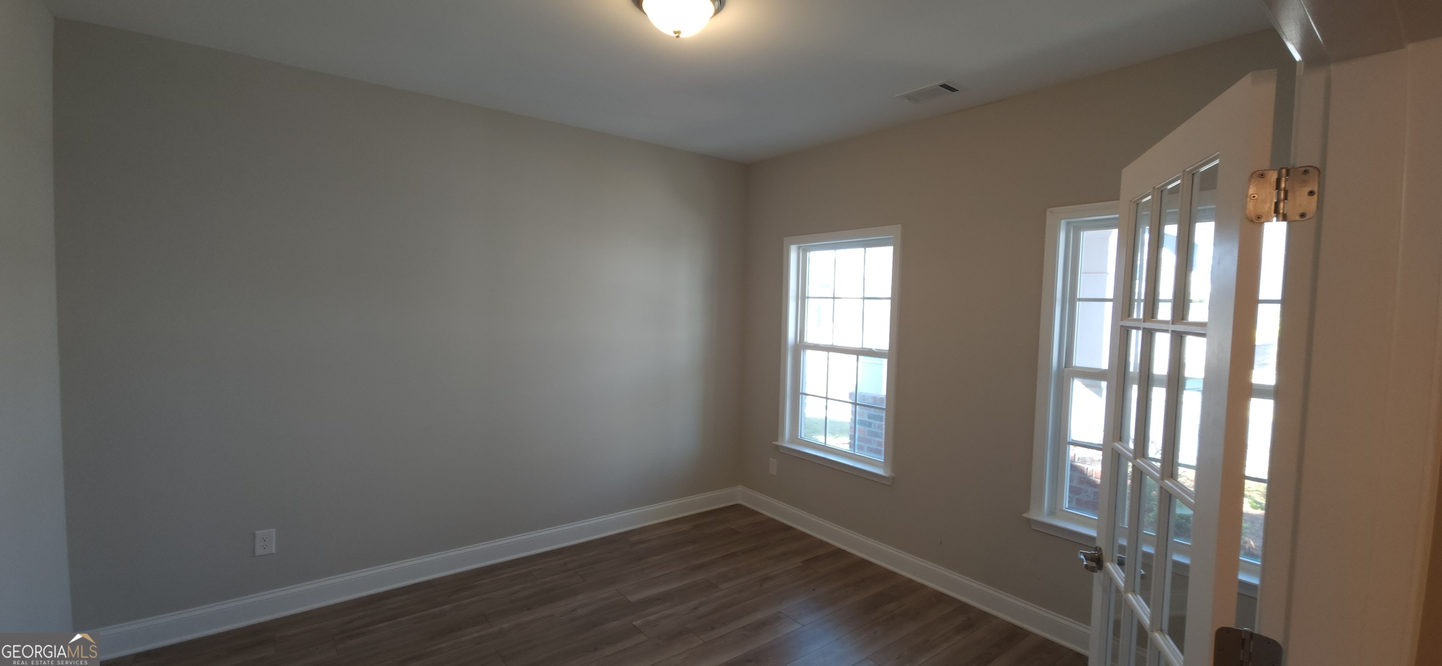 2606 Dorset Lane Grayson, GA 30017 - Photo 15 of 24 a view of an empty room with wooden floor and a window