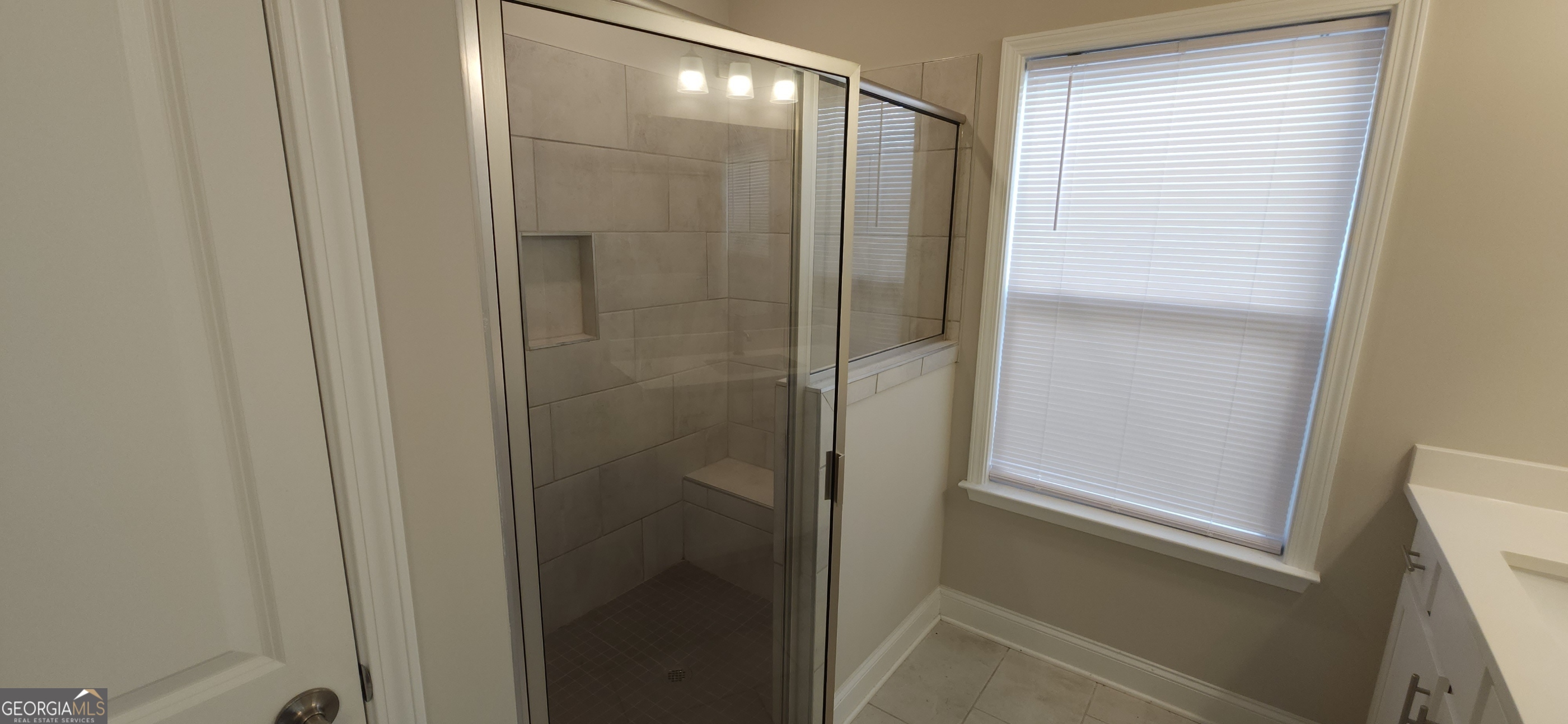 2606 Dorset Lane Grayson, GA 30017 - Photo 21 of 24 a bathroom with a glass shower door and a sink
