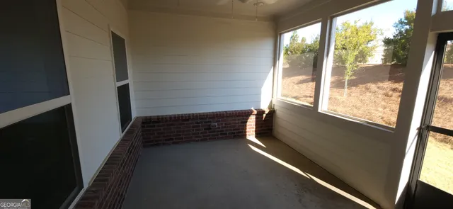 a view of an empty room and a window