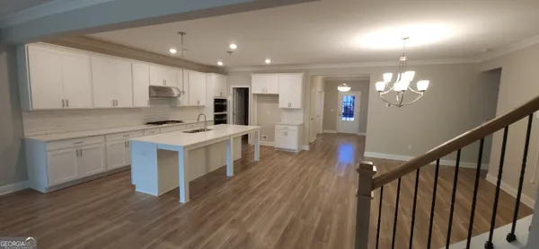 a view of kitchen with sink microwave and stove