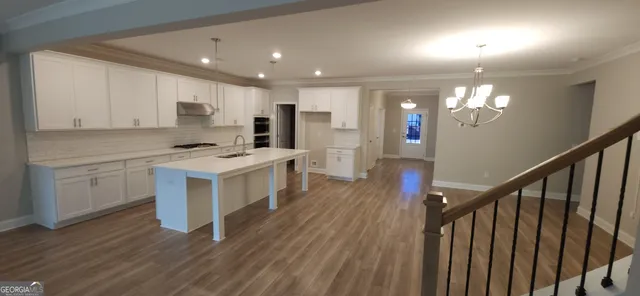 a view of kitchen with sink microwave and stove