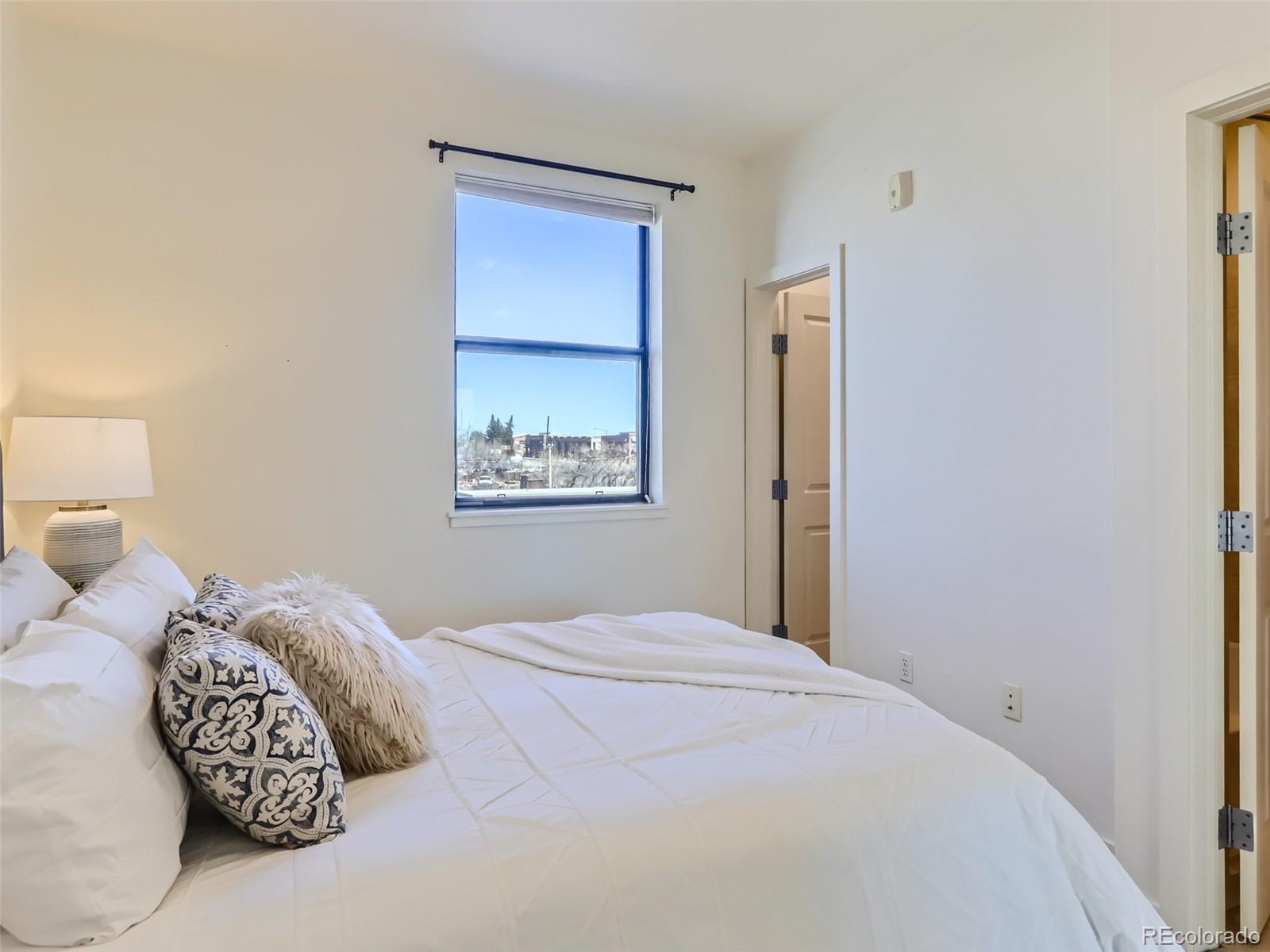 4645 Broadway, Unit B8 Boulder, CO 80304 - Photo 14 of 39 a bedroom with a bed and a painting on the wall