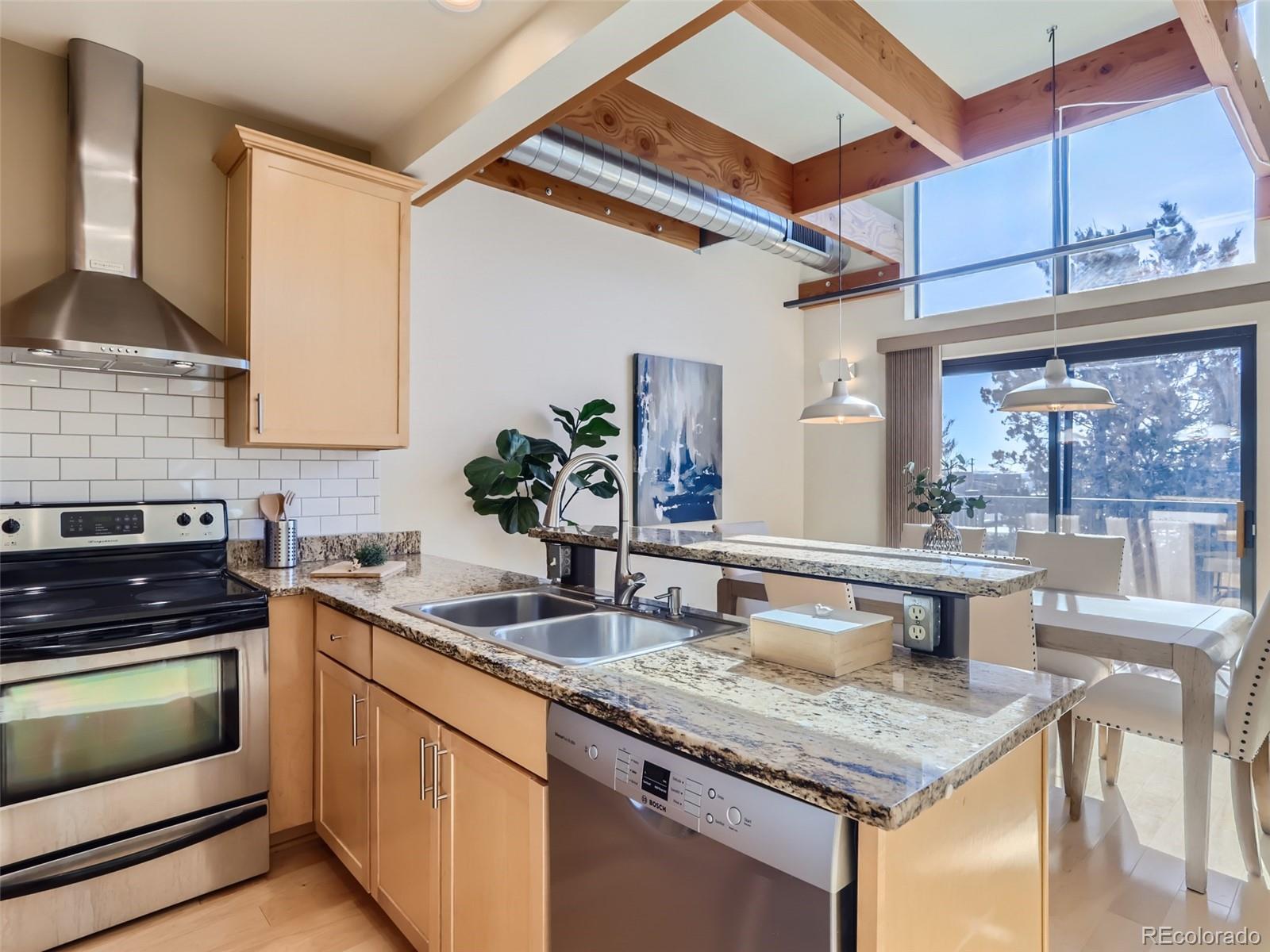 4645 Broadway, Unit B8 Boulder, CO 80304 - Photo 2 of 39 a kitchen with stainless steel appliances granite countertop a sink stove and cabinets