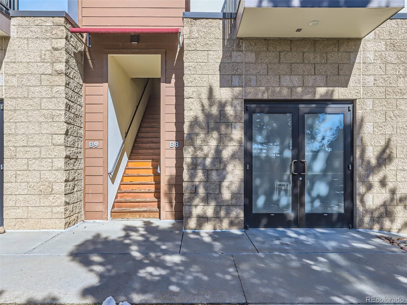 4645 Broadway, Unit B8 Boulder, CO 80304 - Photo 21 of 39 a door view of a brick house with large windows