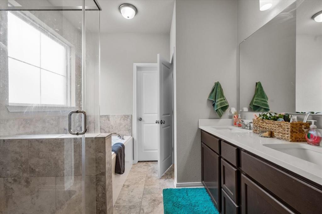 3501 Beutel Road Lorena, TX 76655 - Photo 13 of 33 Full bathroom with double vanity, a stall shower, a garden tub, and tile patterned flooring