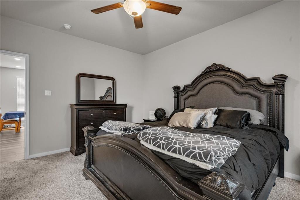 3501 Beutel Road Lorena, TX 76655 - Photo 15 of 33 Bedroom featuring light colored carpet and a ceiling fan