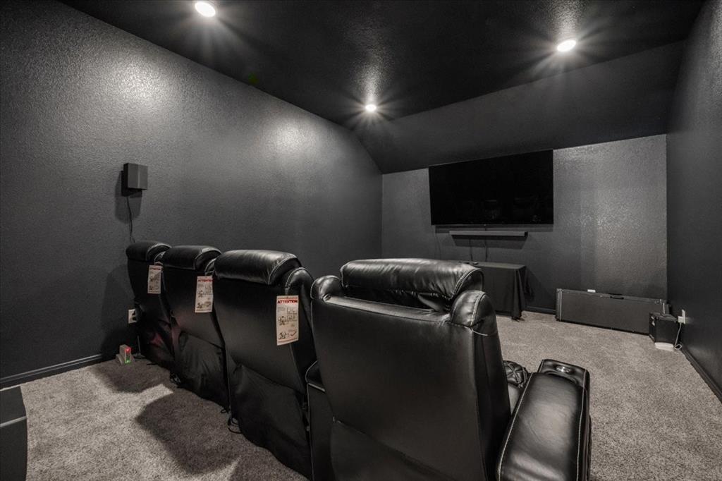 3501 Beutel Road Lorena, TX 76655 - Photo 25 of 33 Home theater room featuring a textured wall, lofted ceiling, and carpet floors