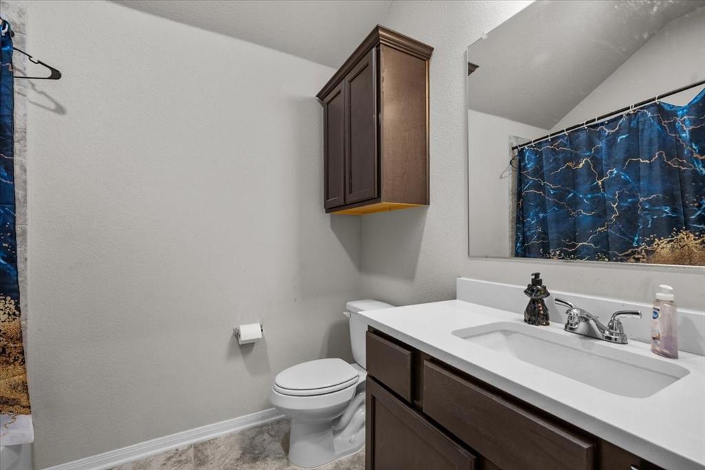3501 Beutel Road Lorena, TX 76655 - Photo 28 of 33 Bathroom with vanity, a textured wall, and lofted ceiling
