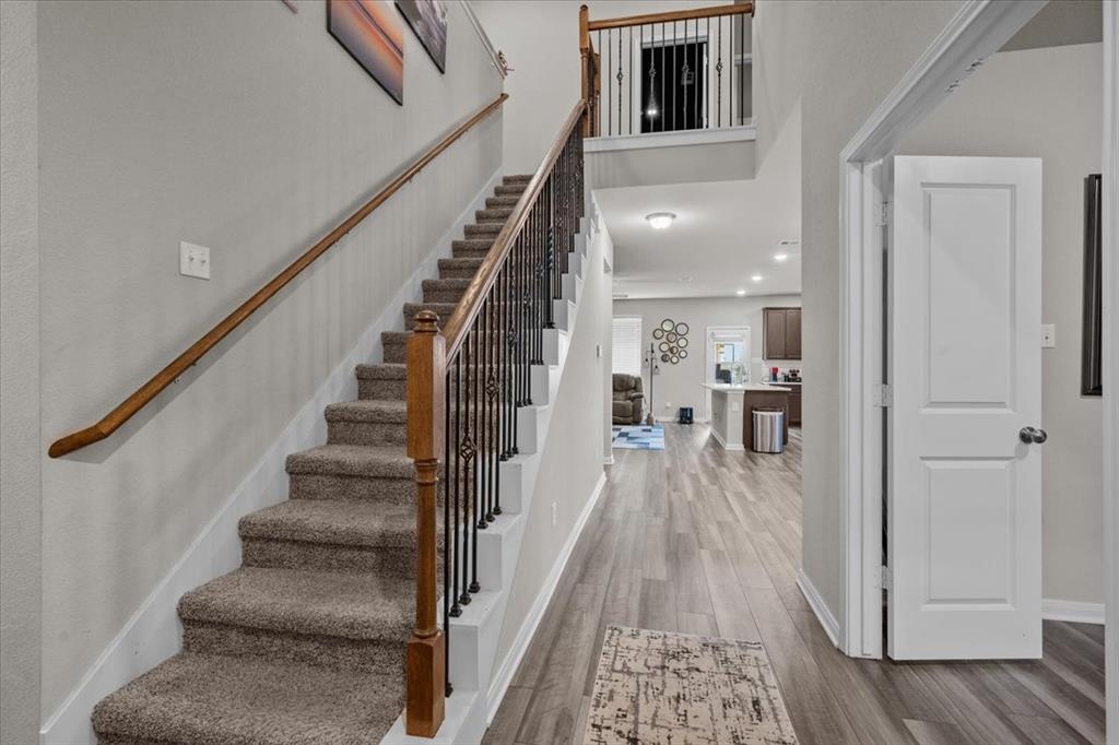 3501 Beutel Road Lorena, TX 76655 - Photo 3 of 33 Staircase with wood finished floors and a high ceiling