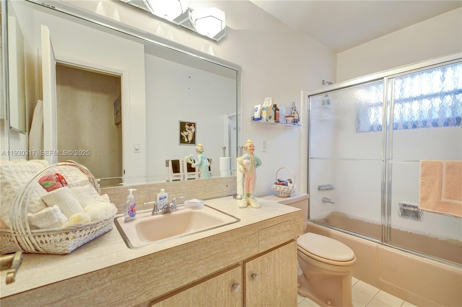 8115 Southwest 92nd Court Miami, FL 33173 - Photo 18 of 42 a bathroom with a sink a toilet and shower