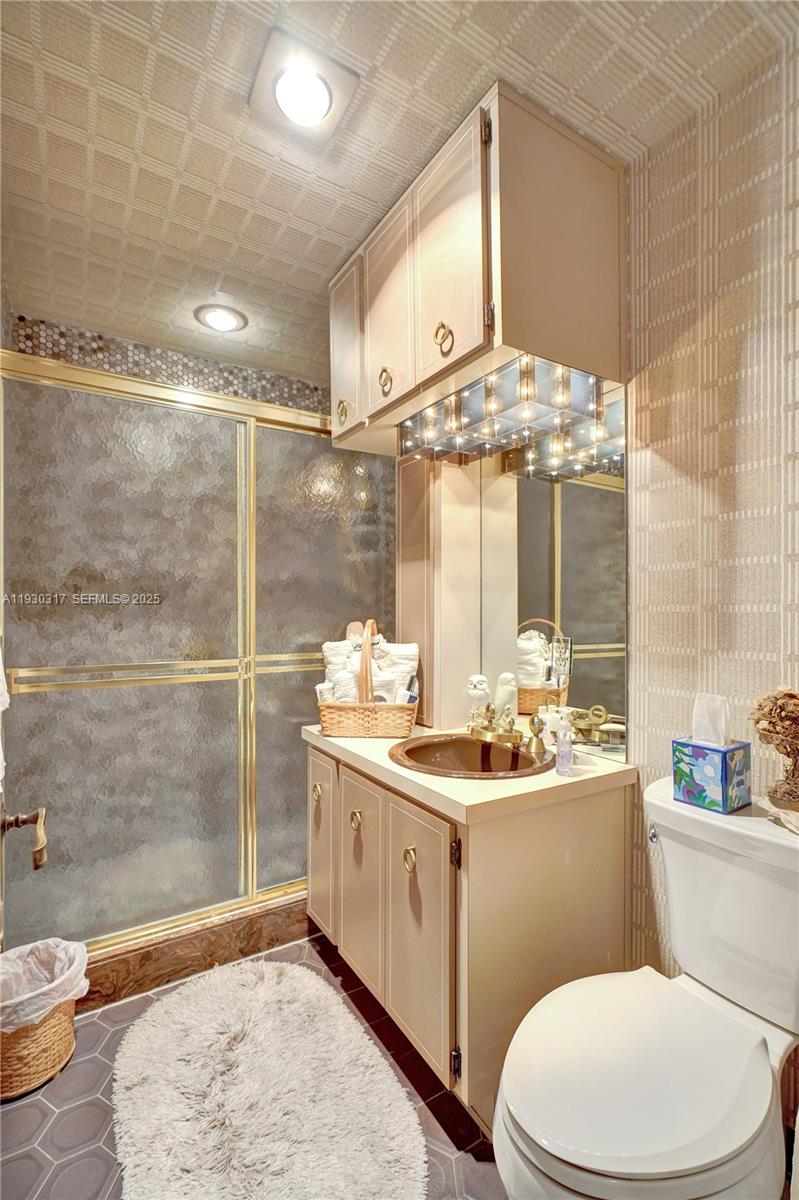 8115 Southwest 92nd Court Miami, FL 33173 - Photo 20 of 42 a bathroom with a sink a toilet and shower