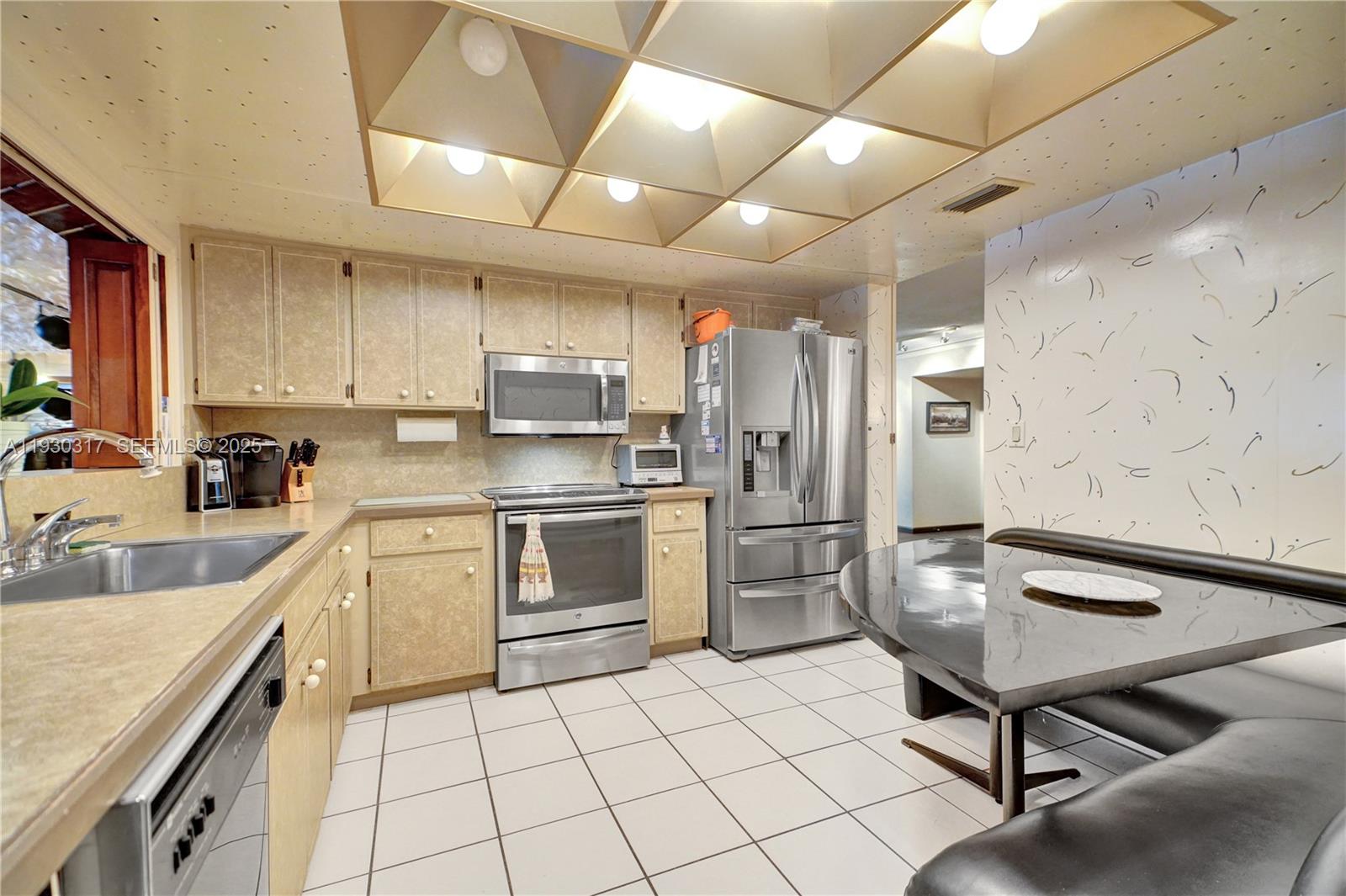 8115 Southwest 92nd Court Miami, FL 33173 - Photo 22 of 42 a kitchen with refrigerator cabinets and a sink