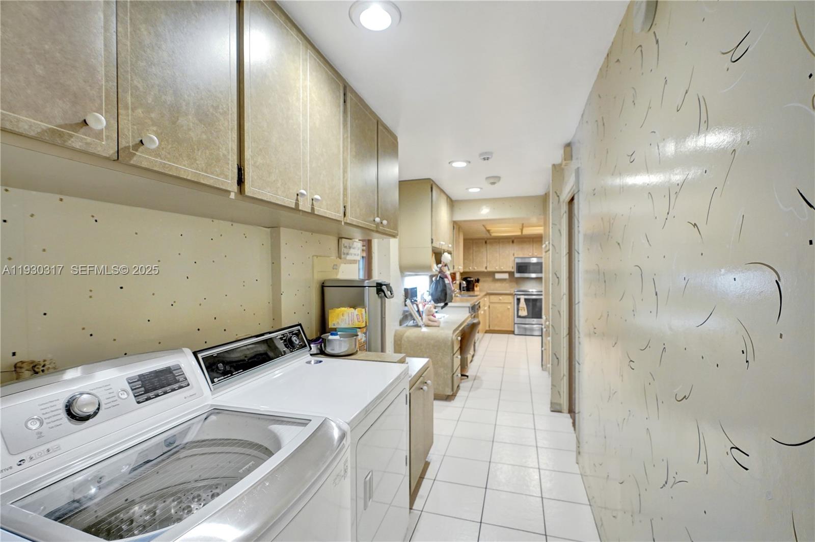 8115 Southwest 92nd Court Miami, FL 33173 - Photo 23 of 42 a view of a kitchen with kitchen island white cabinets and refrigerator