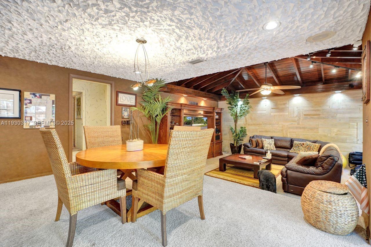 8115 Southwest 92nd Court Miami, FL 33173 - Photo 27 of 42 a dining room with furniture and chandelier