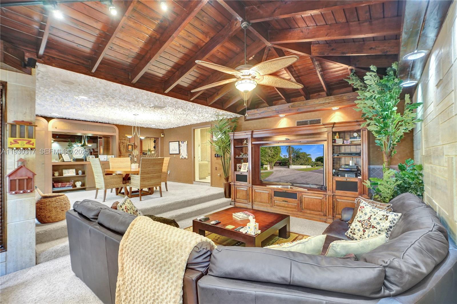 8115 Southwest 92nd Court Miami, FL 33173 - Photo 28 of 42 a living room with furniture and a chandelier