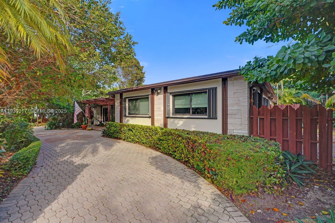 8115 Southwest 92nd Court Miami, FL 33173 - Photo 3 of 42 a front view of a house with a yard and garage