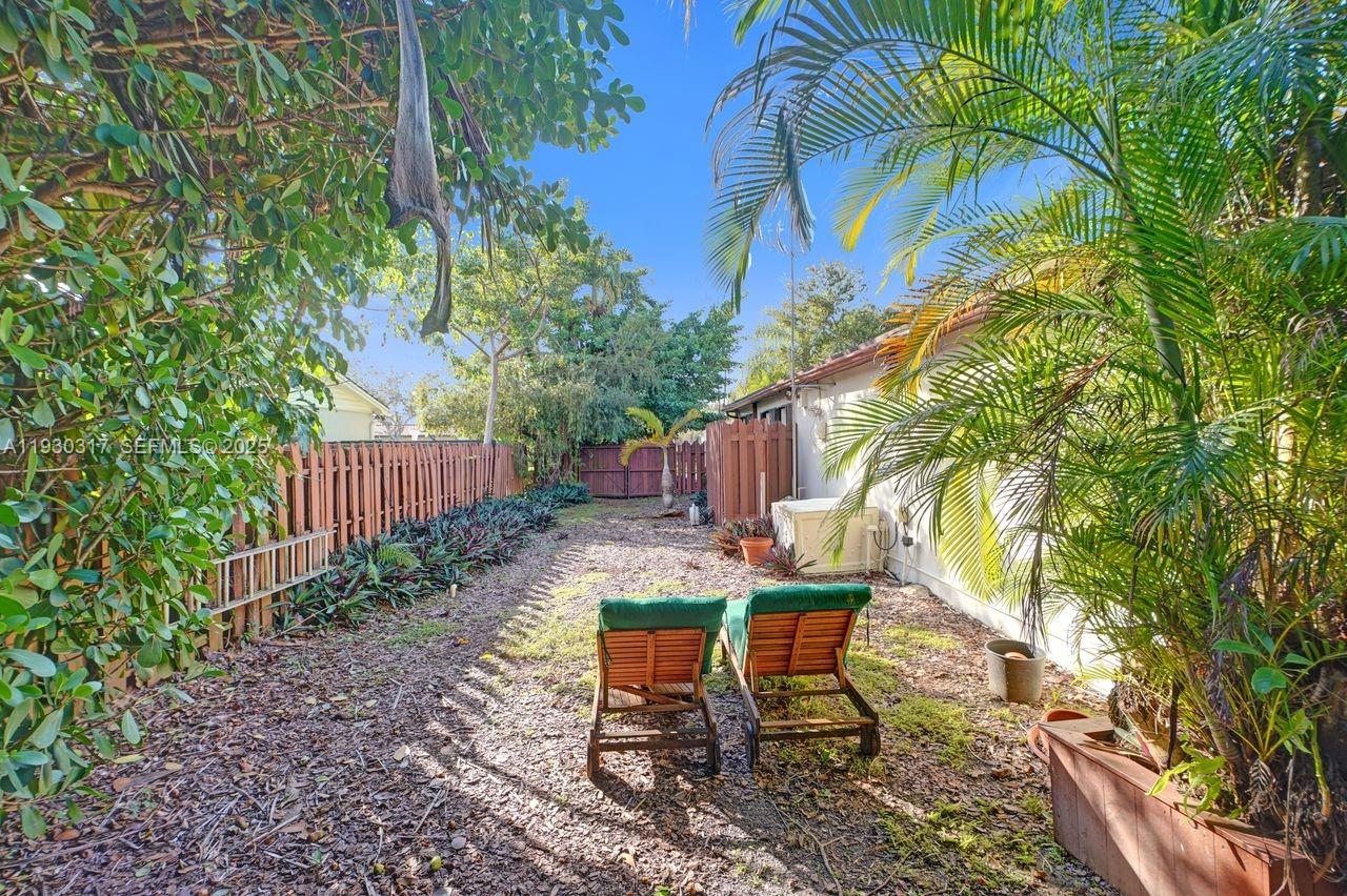 8115 Southwest 92nd Court Miami, FL 33173 - Photo 34 of 42 a view of a yard with a table and chairs in patio