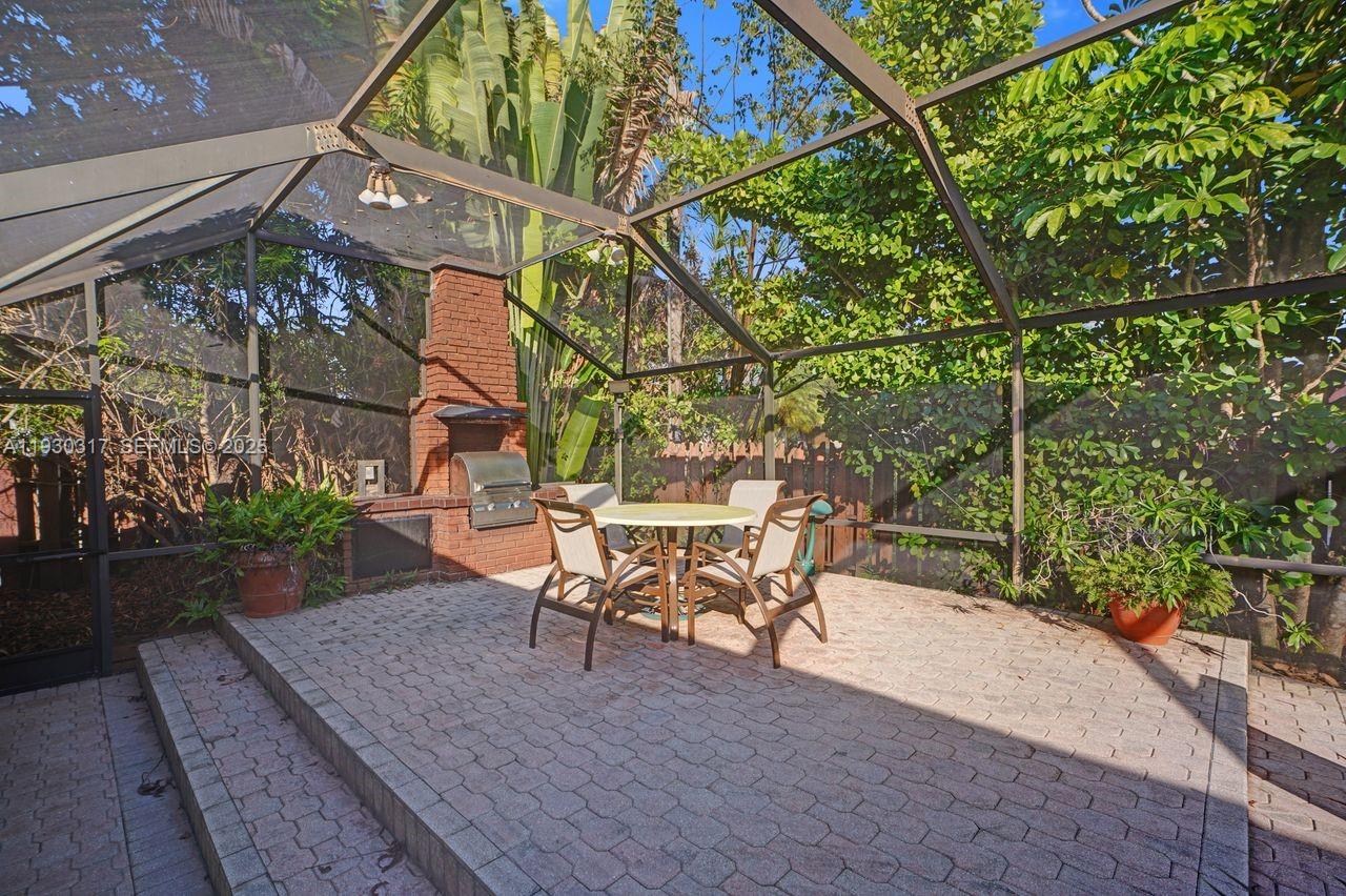 8115 Southwest 92nd Court Miami, FL 33173 - Photo 37 of 42 a backyard of a house with table and chairs