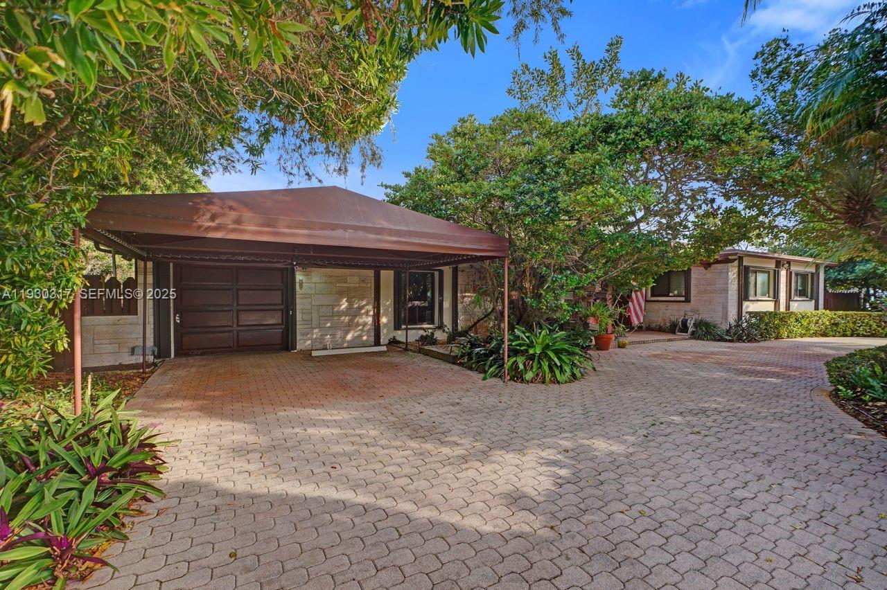 8115 Southwest 92nd Court Miami, FL 33173 - Photo 5 of 42 a front view of a house with garden
