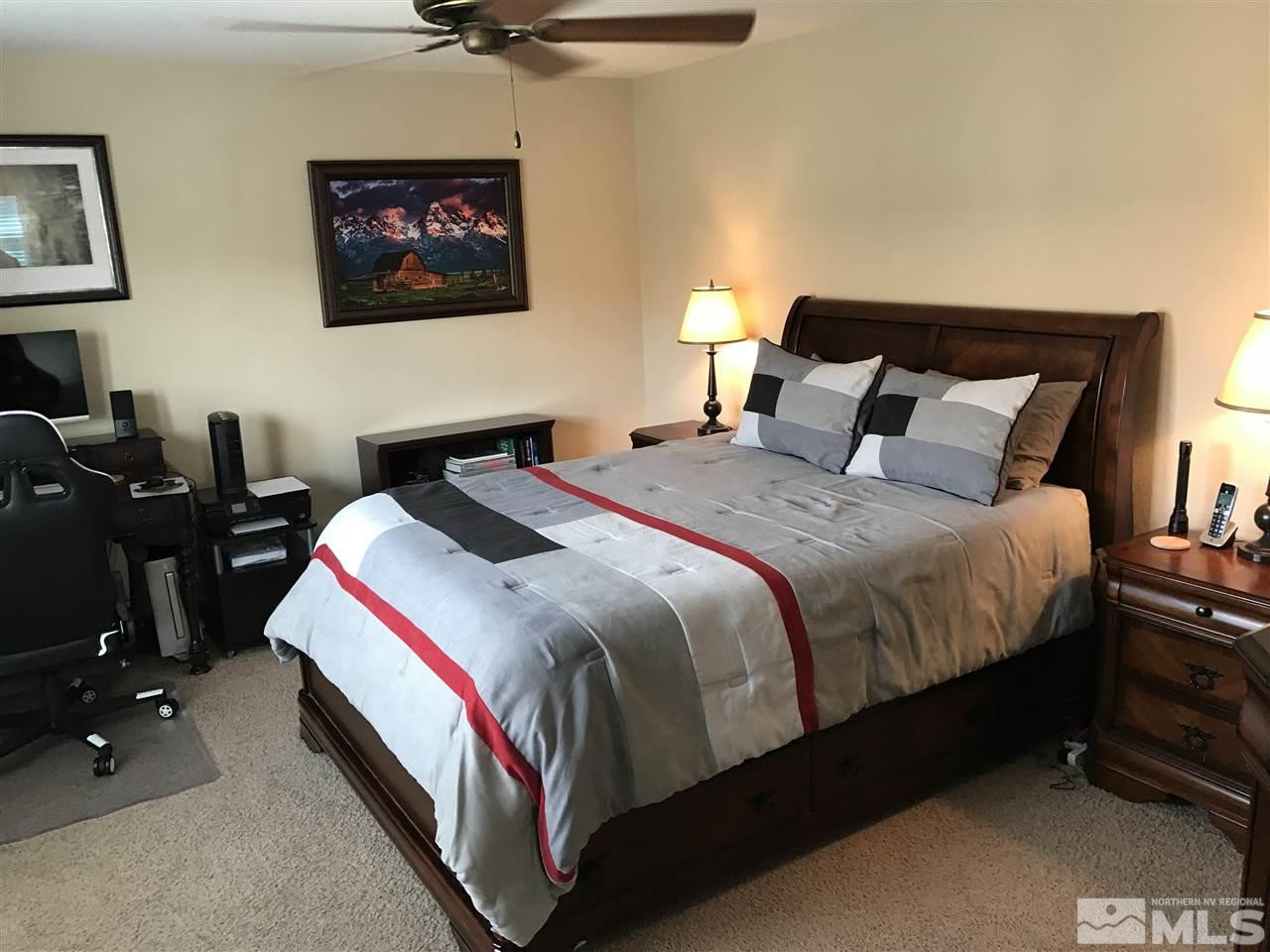 2055 Black Sand Drive Reno, NV 89521 - Photo 16 of 17 a bedroom with a bed and a lamp on dresser