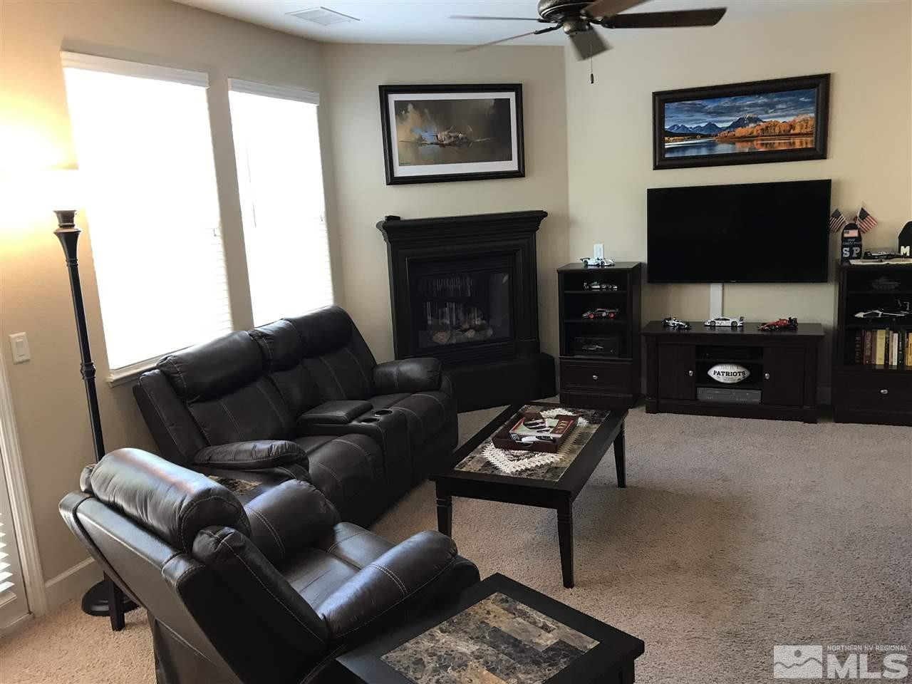 2055 Black Sand Drive Reno, NV 89521 - Photo 4 of 17 a living room with furniture a flat screen tv and a fireplace