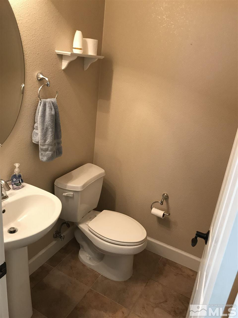 2055 Black Sand Drive Reno, NV 89521 - Photo 9 of 17 a white toilet sitting next to a bathroom sink