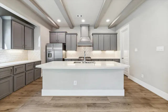 a view with kitchen island a sink wooden floor and view living room