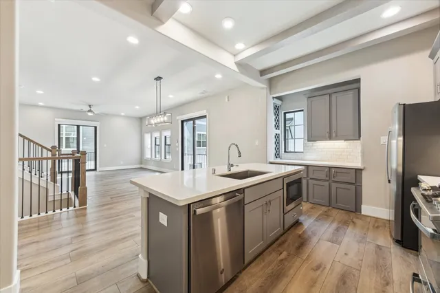 a kitchen with a sink stove and refrigerator