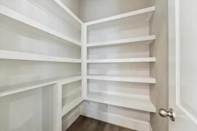 a view of walk in closet with empty racks