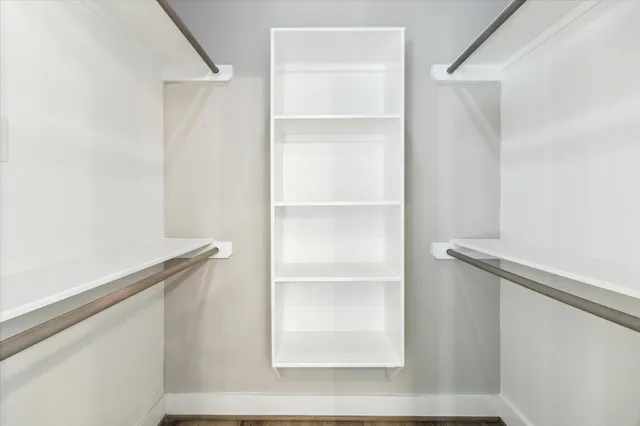 a view of walk in closet with empty racks