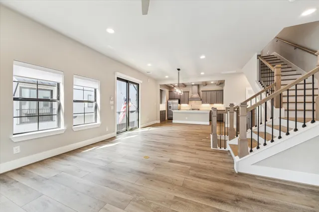 a view of dining room with wooden floor and windows