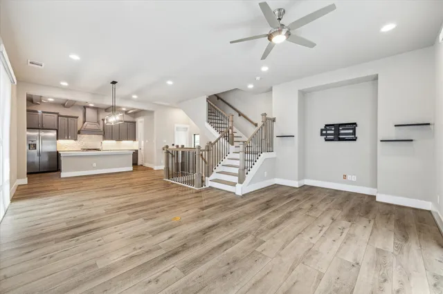 a view of a living room a kitchen and a wooden floor