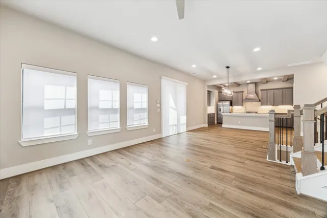a view of a living room with wooden floor and a large window